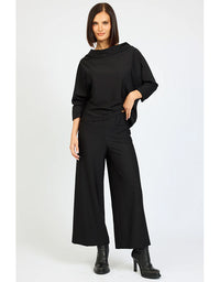 Woman wearing a black outfit on a white background