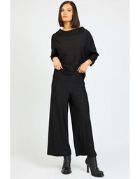 Woman wearing a black outfit on a white background