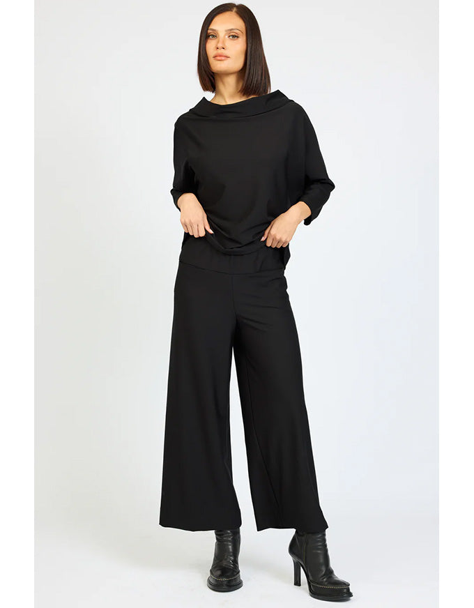 Woman wearing a black outfit on a white background