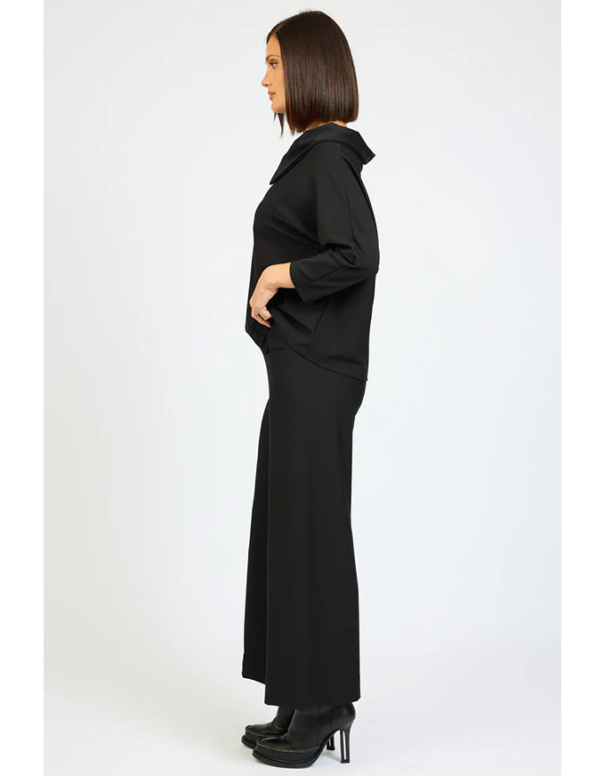 Woman wearing a long black dress on a white background