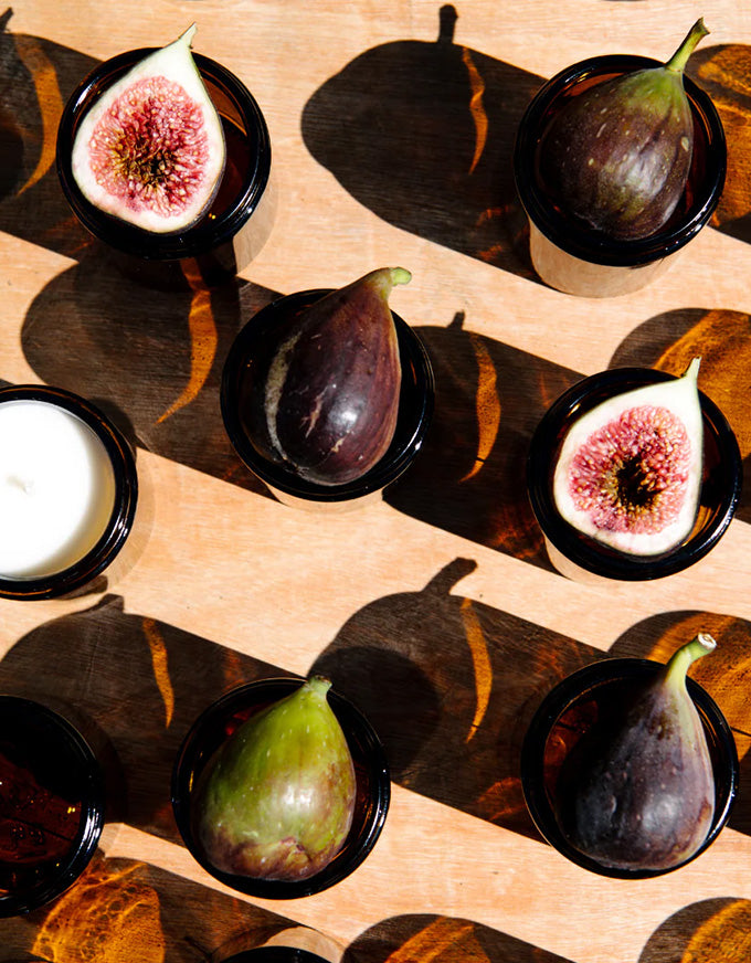 Figs arranged on a wooden surface with a warm glow