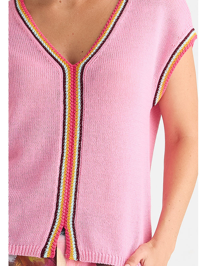 A close-up of a pink knit top with a V-neck and short sleeves, featuring multicolor striped trim in pink, yellow, white, and black along the neckline and sleeve edges. Crochet Trim Tank - Begonia Park