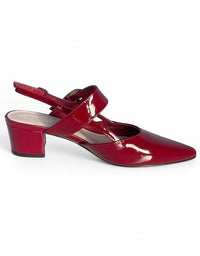 Red patent leather shoe on a white background