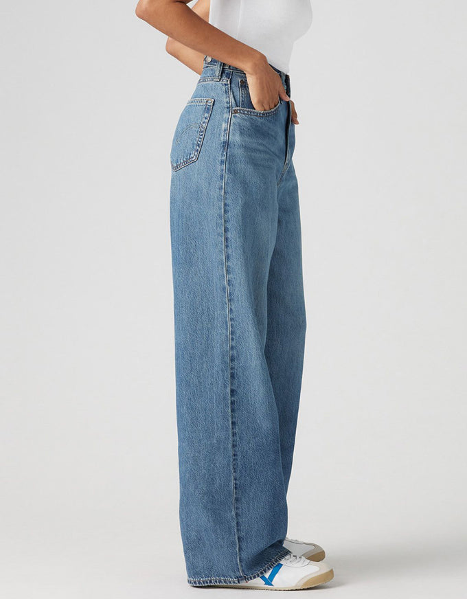 Person wearing blue jeans on a plain background. Cinch Baggy Jeans - Chasing Dreams