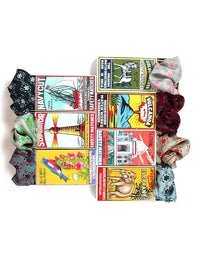 Colorful vintage-style matchbox covers with assorted silk scarves on a white background