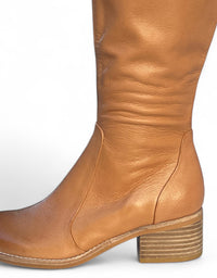 Tan leather boot on a white background