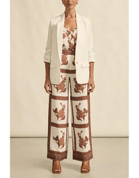 Woman wearing a patterned outfit with a beige background